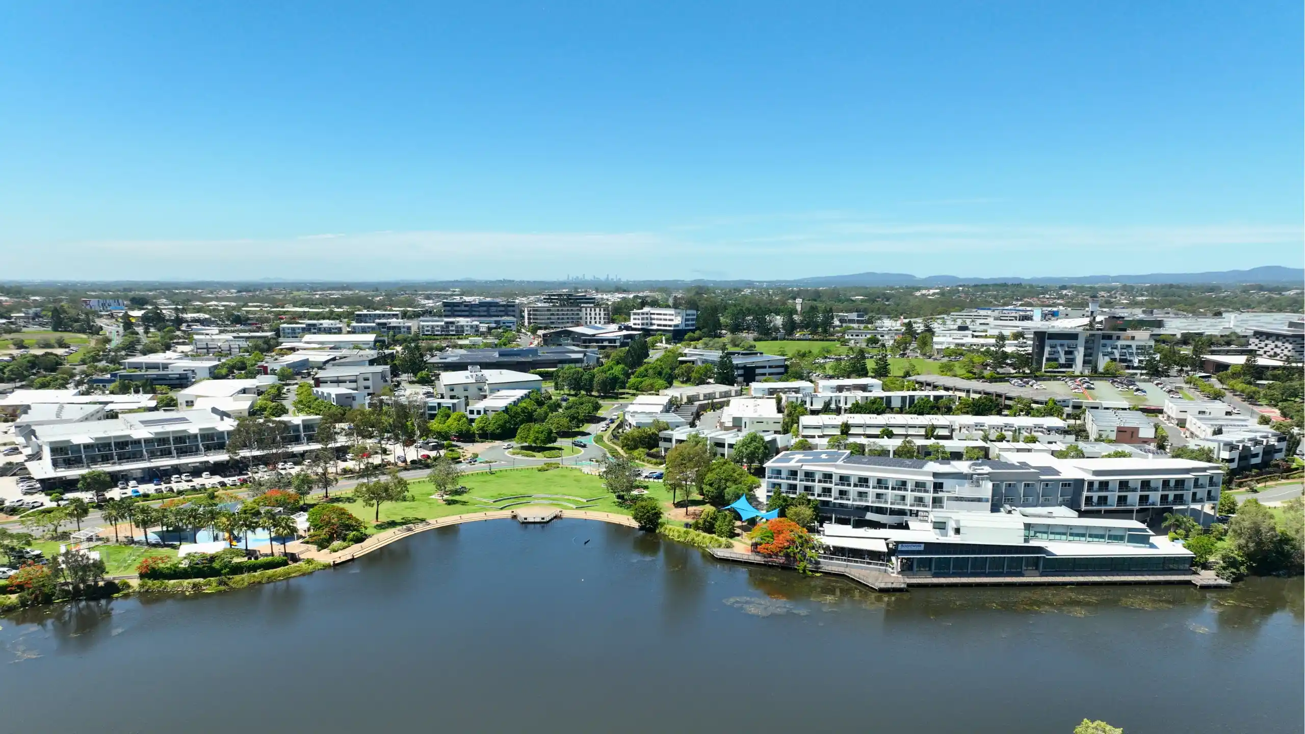 An aerial photograph over the North Lakes lake precinct, flown by Red Ox Digital