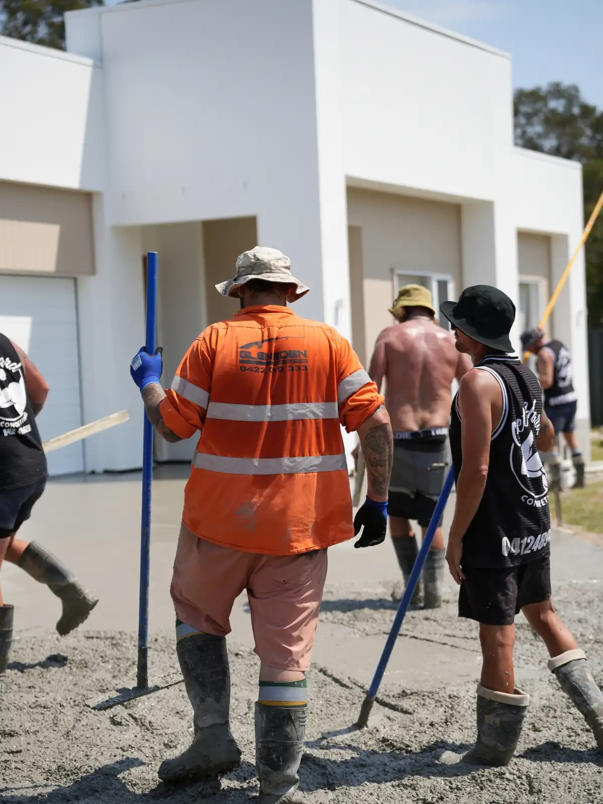 A concreting crew finishing a slab in Moreton Bay, photographed on site by Red Ox Digital